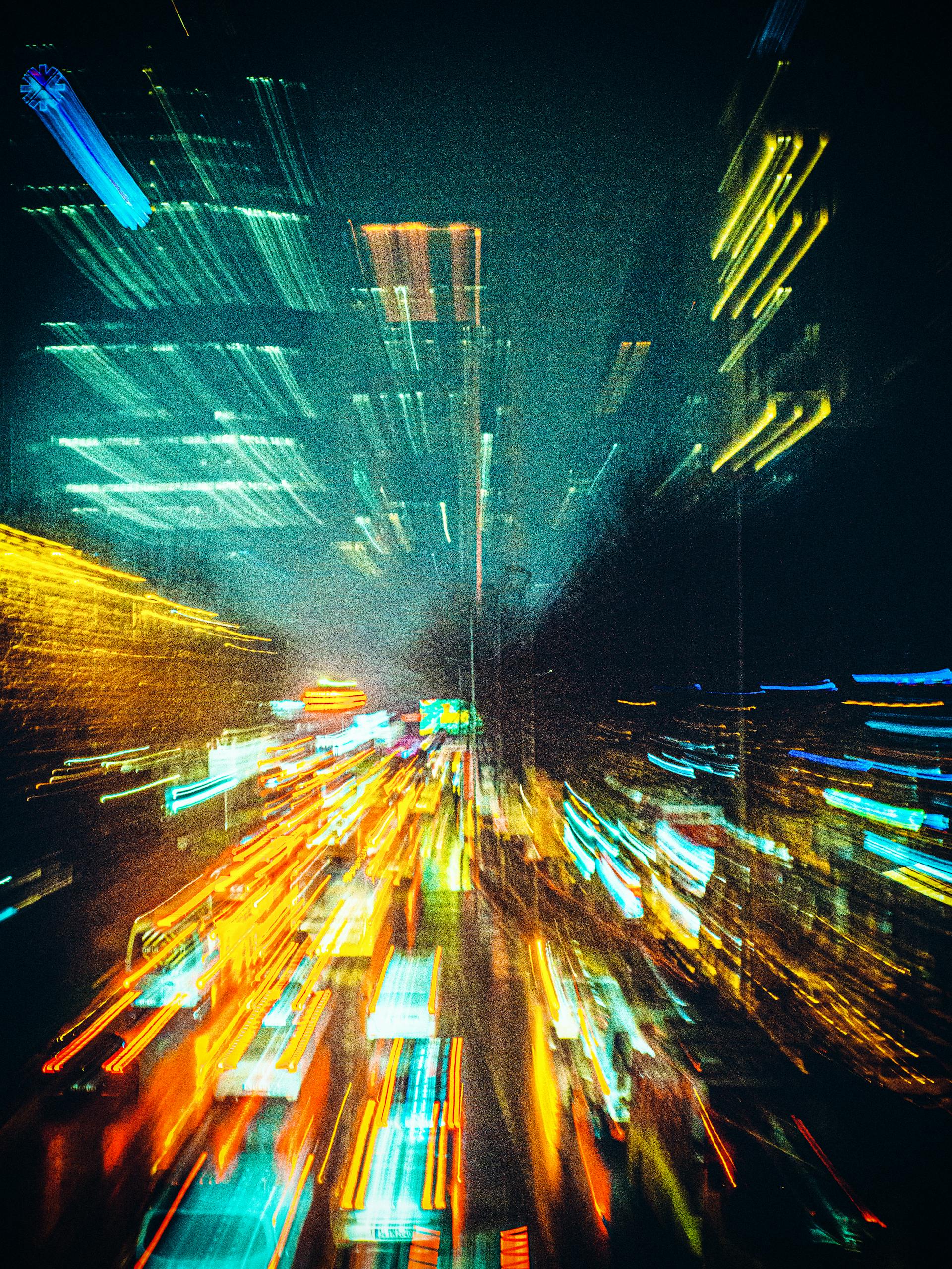 Blurred night view of vibrant city lights and traffic in İstanbul, creating a vivid urban scene.