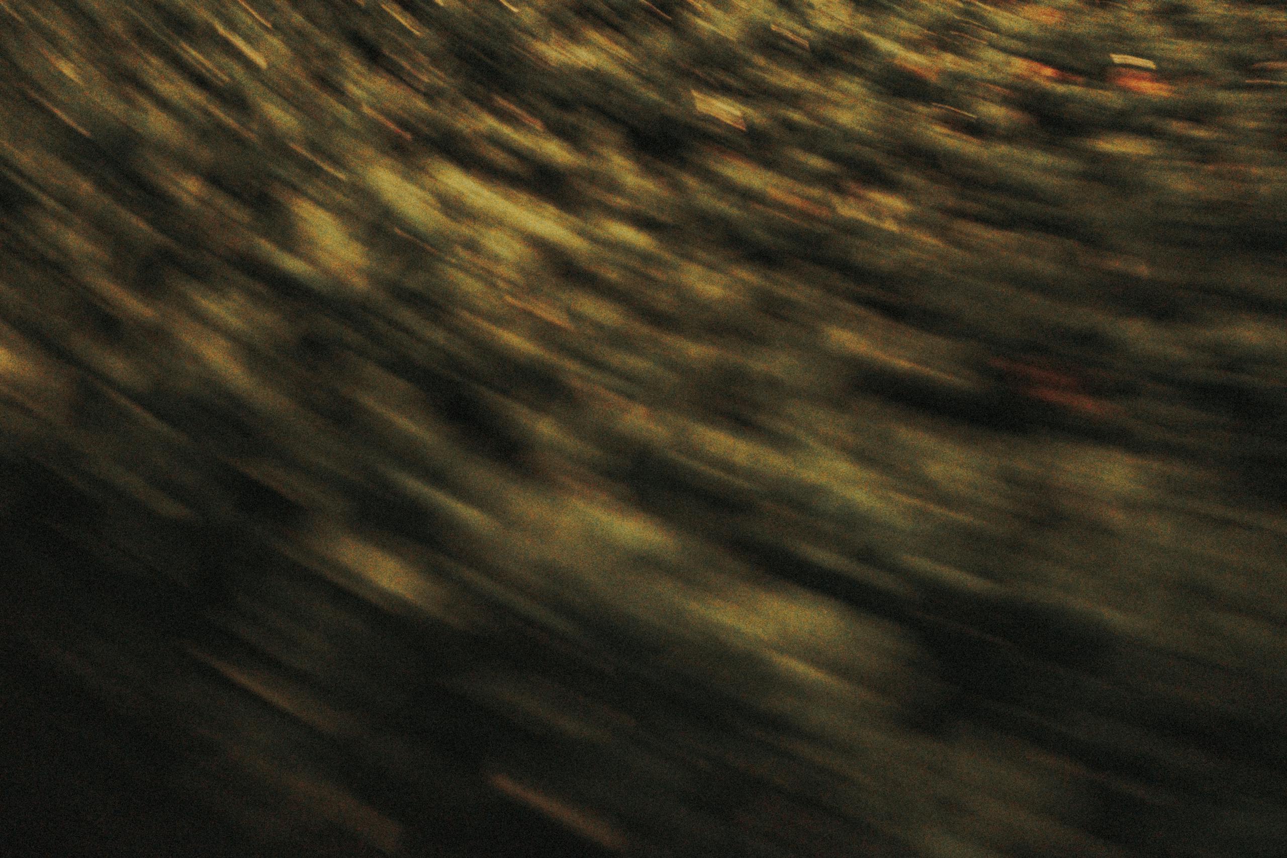 Vibrant abstract image showcasing dynamic motion blur with a green color palette.